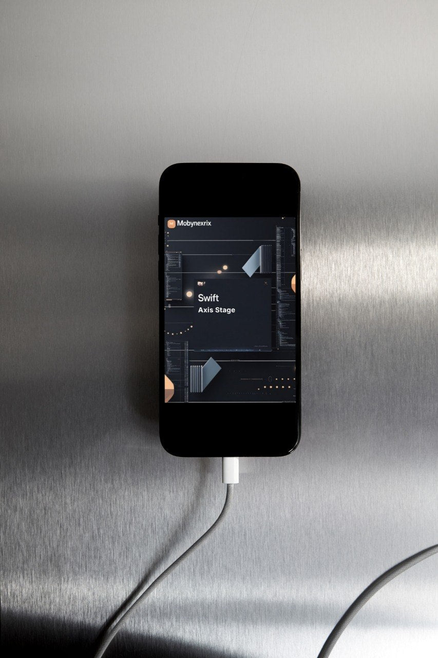 Smartphone displaying a music app on a metallic surface