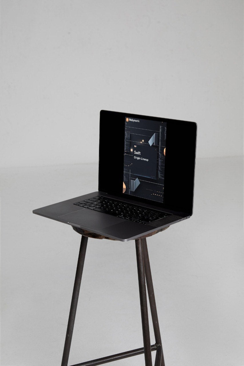 Black laptop on a stand against a light gray background